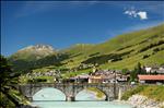 The river Inn with the bridge of the village of S-chanf with nice Engadine weather.